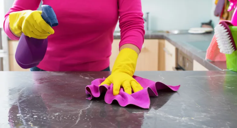 woman cleaning kitchen counter